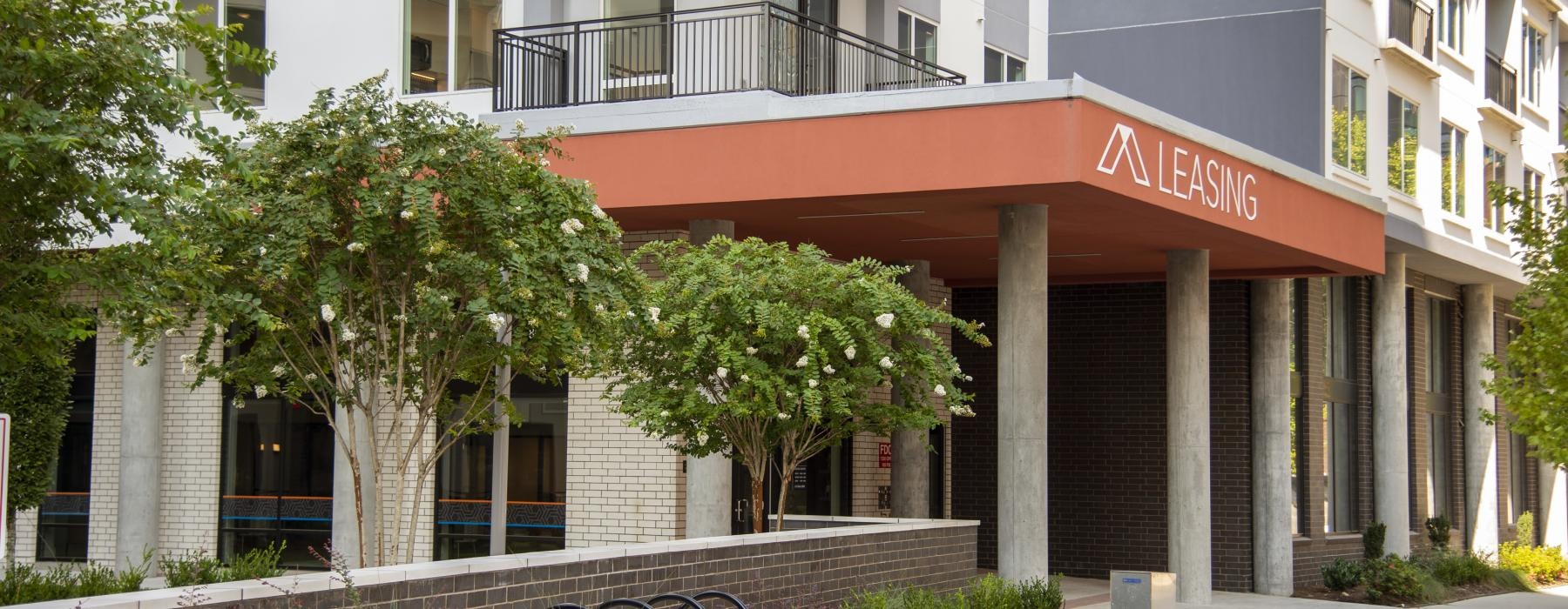 a building with a walkway and trees