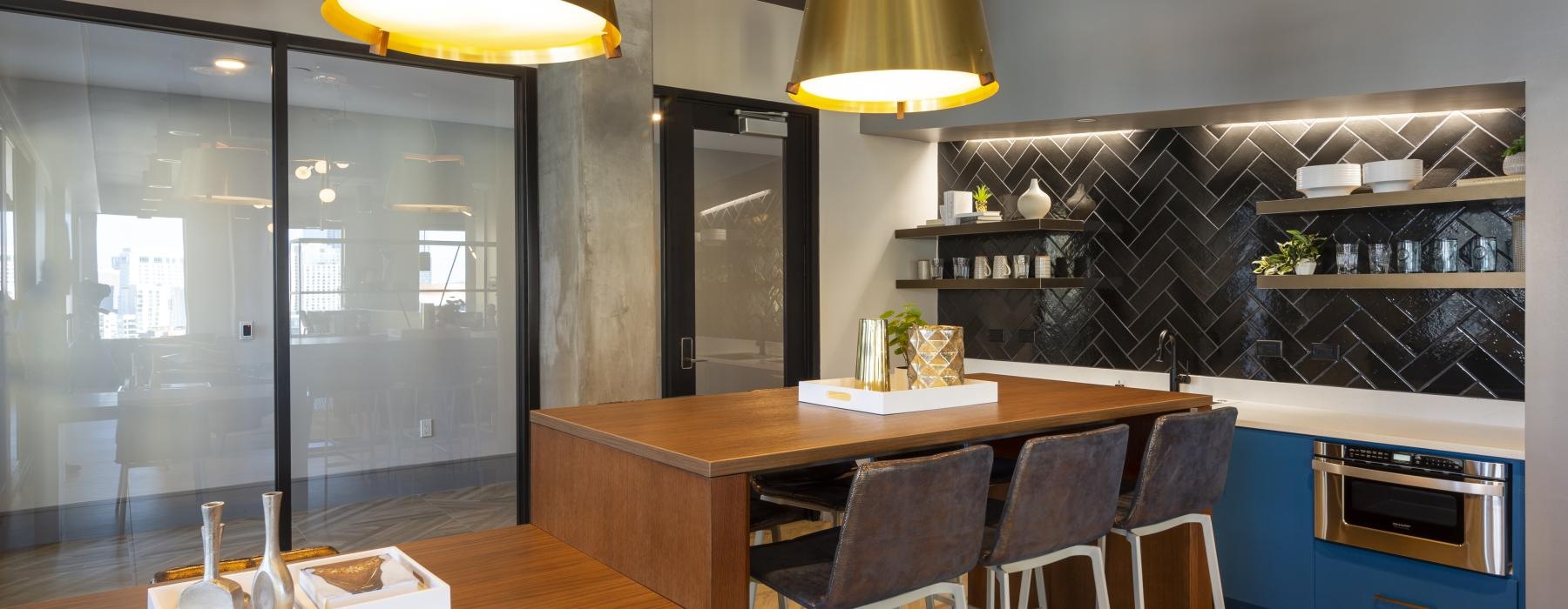 a kitchen with a bar and a table